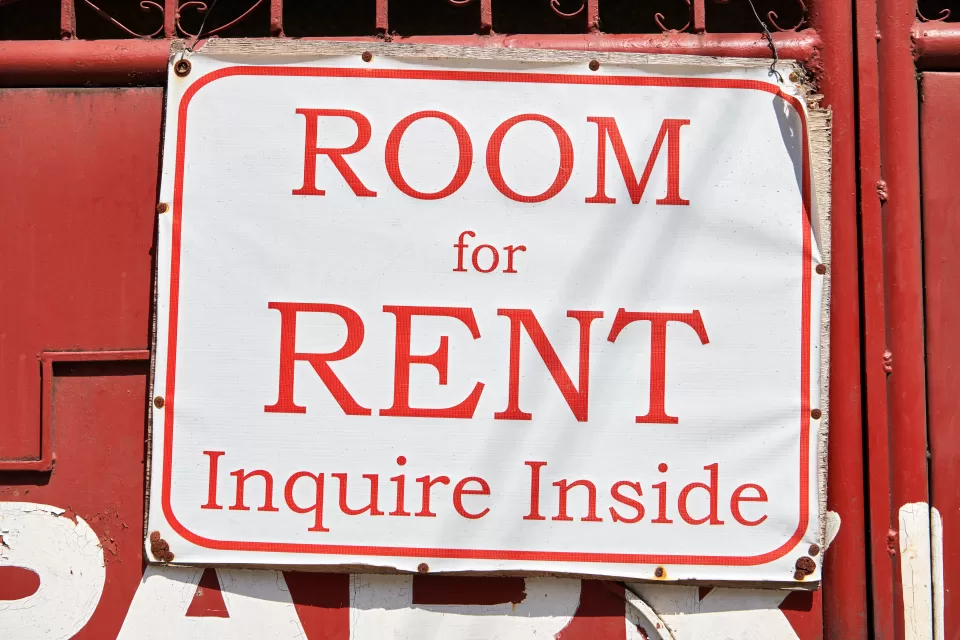 Red on white 'Room for Rent, Inquire Inside' sign